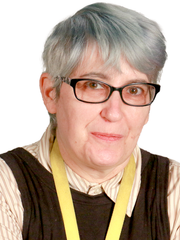 photo of a white woman with light blue hair and glasses, wearing a striped shirt under a tunic